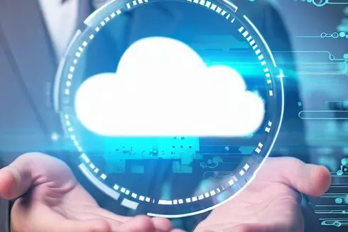 Two hands outstretched beneath a glowing cloud icon surrounded by digital circuitry, representing cloud computing technology.